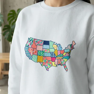 White sweatshirt with a colorful patchwork map of the United States.
