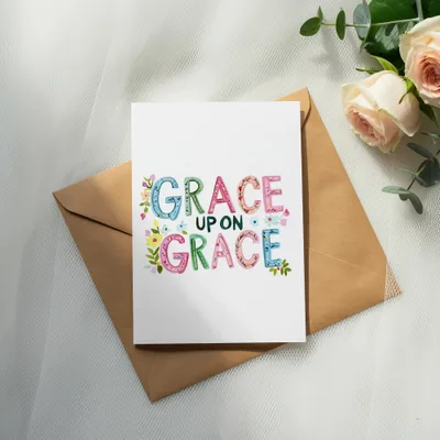 Card with "Grace Upon Grace" text and floral accents on an envelope.