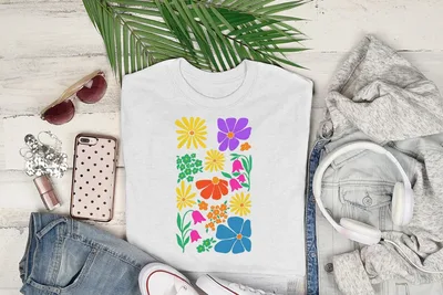 White t-shirt with colorful floral and geometric pattern.