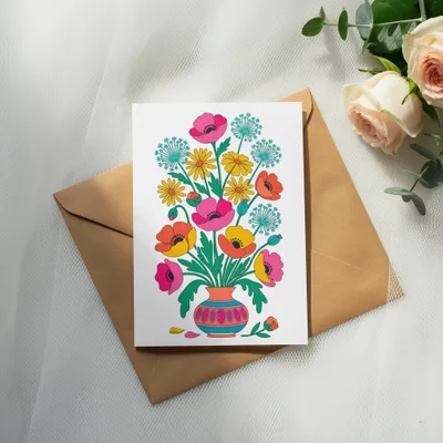 Card with colorful folk art floral illustration on brown envelope.
