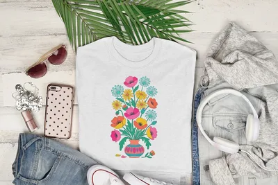 White t-shirt with colorful floral bouquet illustration in a vase.