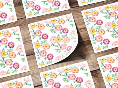 Floral patterned cards with pink and yellow flowers on a wooden background.