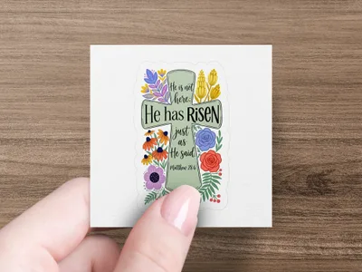 He has risen text on a cross design with floral accents.
