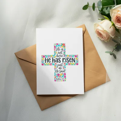Floral cross greeting card with "He has risen" text from Matthew 28:6.