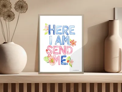 Colorful "HERE I AM SEND ME." text art with floral accents on a shelf.