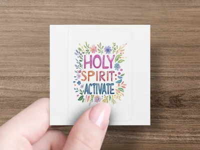 Hand holding square sticker with "HOLY SPIRIT: ACTIVATE" and floral design.