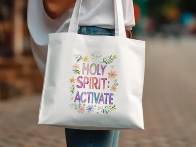 White tote bag with "Holy Spirit: Activate" text surrounded by floral watercolor design.