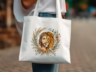 White tote bag with a circular floral design featuring Jesus and a lion.