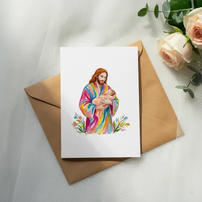 Watercolor painting of Jesus holding a baby, on a card.