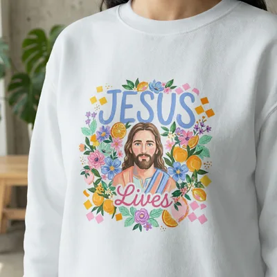 Jesus Lives text with floral and fruit border on white sweatshirt.
