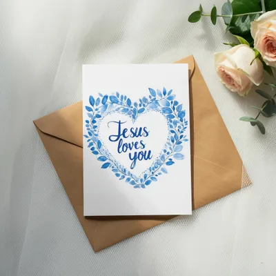 Greeting card with blue heart wreath and text "Jesus loves you."