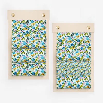 Two fabric swatches with a blue, pink, and yellow floral pattern.