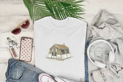 White t-shirt with leopard print tent graphic, surrounded by jeans, sunglasses, and headphones.