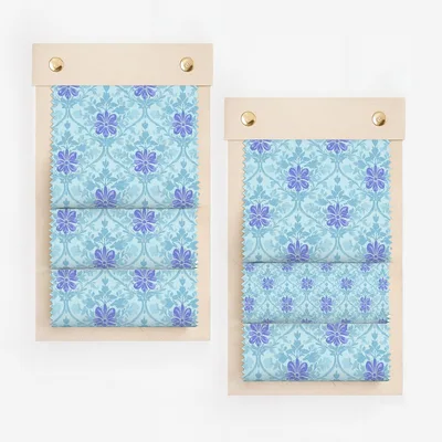 Floral fabric swatches on wooden boards.