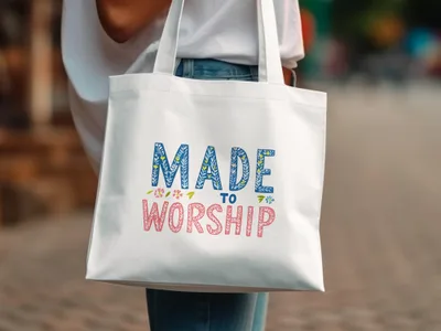 White tote bag with "Made to Worship" text in colorful lettering.