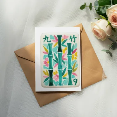 Card with painted bamboo and flowers on a brown envelope with roses.