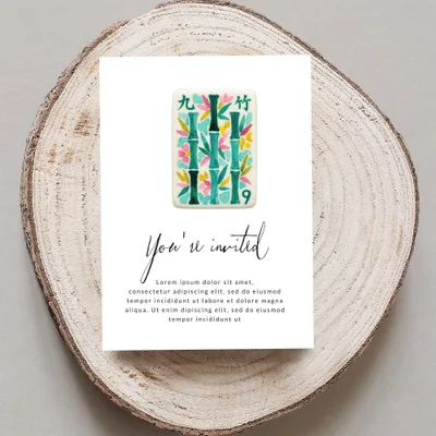 Invitation card with bamboo design and "You're invited" text.