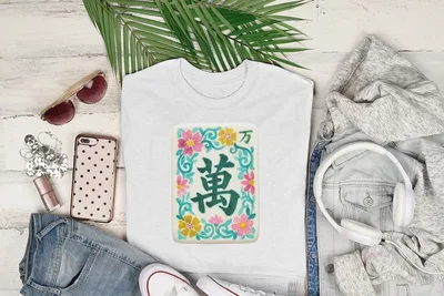 White t-shirt with a floral Mahjong tile design.