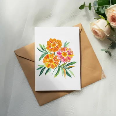 Watercolor painting of orange and pink flowers on a card with a brown envelope.