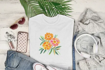 White t-shirt featuring a watercolor floral design of pink and orange flowers.