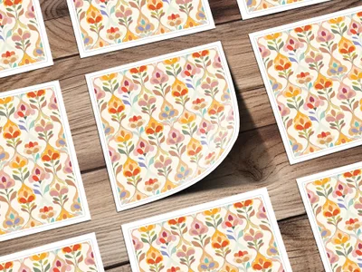 Scattered floral pattern cards with orange, blue, and yellow accents on wood grain background.