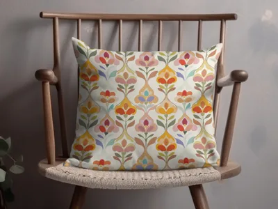 Decorative throw pillow with a colorful floral pattern on a wooden chair.