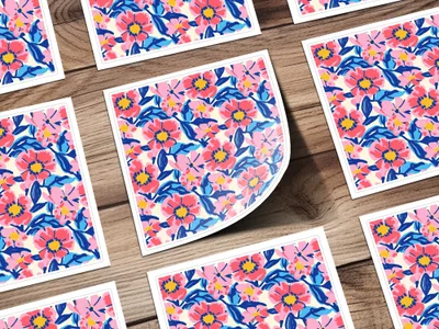 Floral pattern stickers on a wooden background, one sticker peeled.
