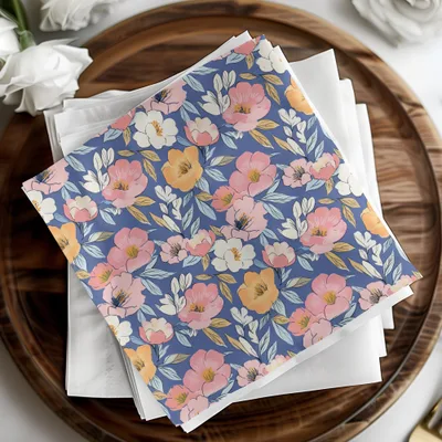 Blue floral napkins with pink and yellow flowers on a wooden tray.
