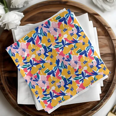 Floral patterned napkins on a wooden tray with white cloth.