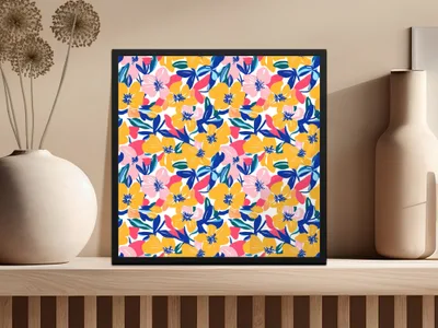 Floral print artwork in a black frame on a shelf.