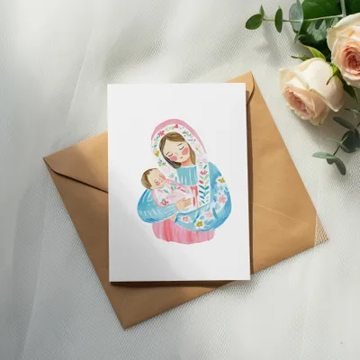 Watercolor illustration of Mary holding baby Jesus on a card, with roses and eucalyptus.