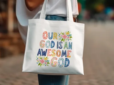 White tote bag with "Our God is an Awesome God" text and floral accents.