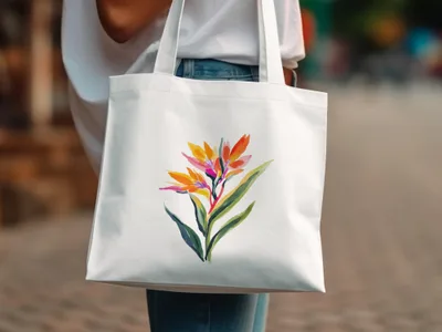 White tote bag with a watercolor bird of paradise flower design.