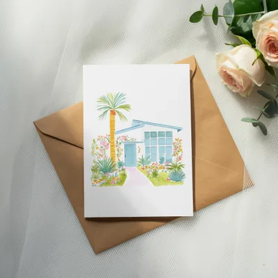 Watercolor illustration of a mid-century modern house with palm trees and flowers.