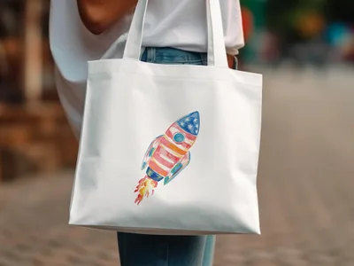 White tote bag with a watercolor rocket ship design.