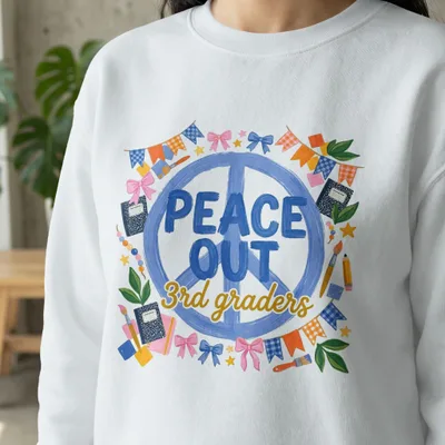 White sweatshirt with "PEACE OUT 3rd graders" and colorful school supplies.
