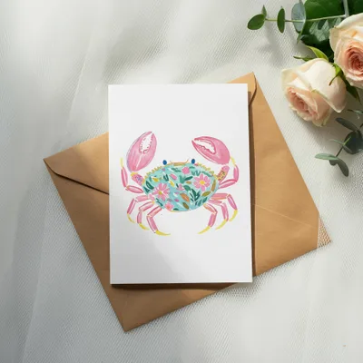 Watercolor crab card with floral pattern on a brown envelope.