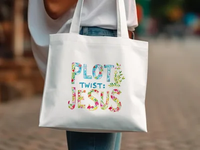 White tote bag with "PLOT TWIST: JESUS" in colorful floral lettering.