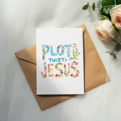 Card with "PLOT TWIST: JESUS" in colorful, floral lettering on a brown envelope.