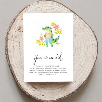Invitation card with a cartoon alligator and floral illustrations.