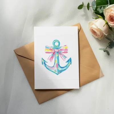 Watercolor anchor with a colorful bow on a white card and brown envelope.