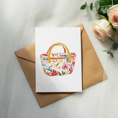 Floral basket illustration on a card with a brown envelope and roses.