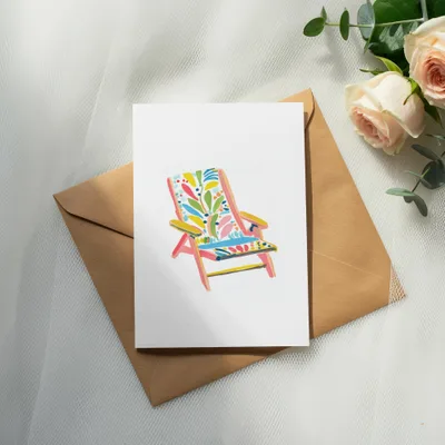 White card with a colorful, patterned beach chair illustration on a brown envelope.