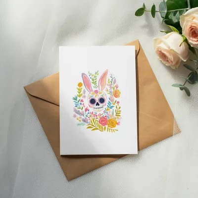 Easter bunny skull illustration on a card with a brown envelope.