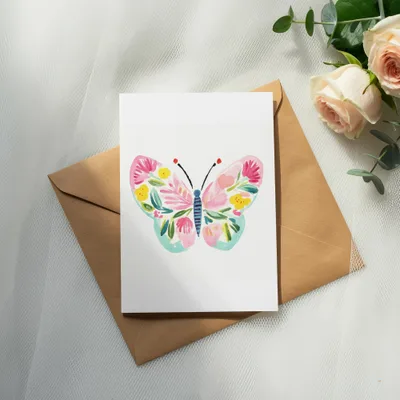 Card with butterfly illustration on brown envelope with roses.