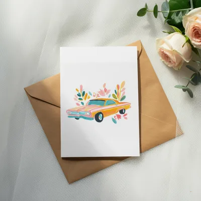 Watercolor illustration of a vintage orange car with floral accents on a white card.