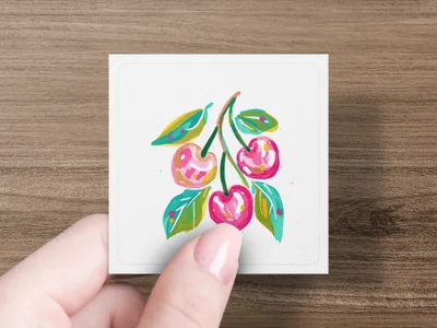 Hand holding card with painted cherries and leaves.