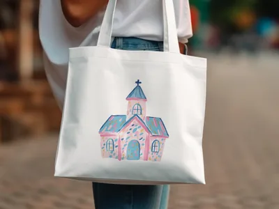 White canvas tote bag featuring a whimsical watercolor illustration of a pastel church.