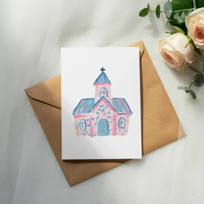 Watercolor illustration of a pink and blue church on an envelope with roses.