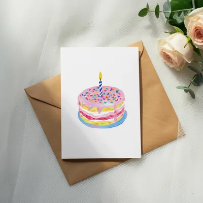Birthday cake illustration with candle on card with envelope and roses.